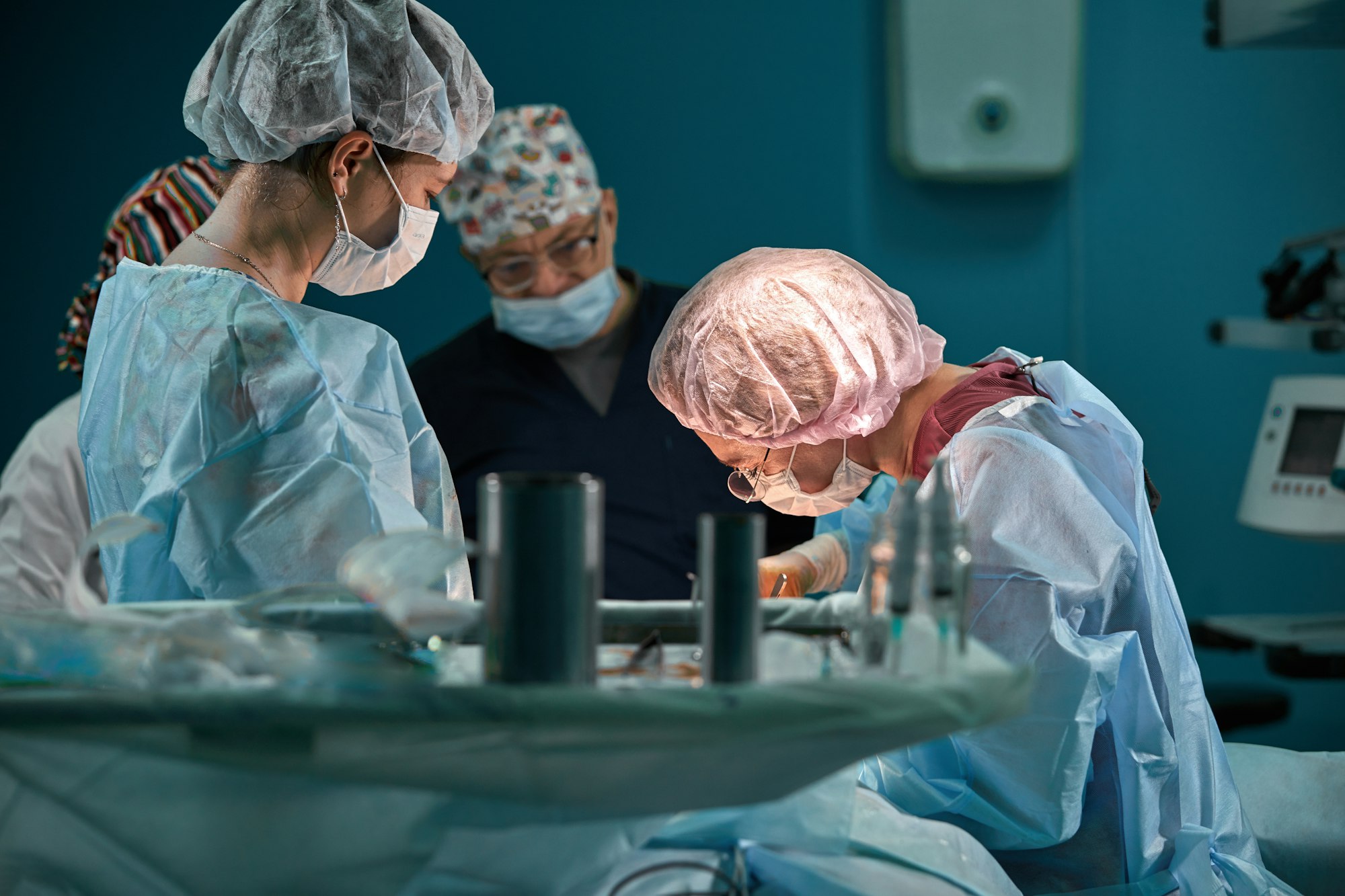 Group of surgeons in operating theater. Medical team performing surgery in operation room.