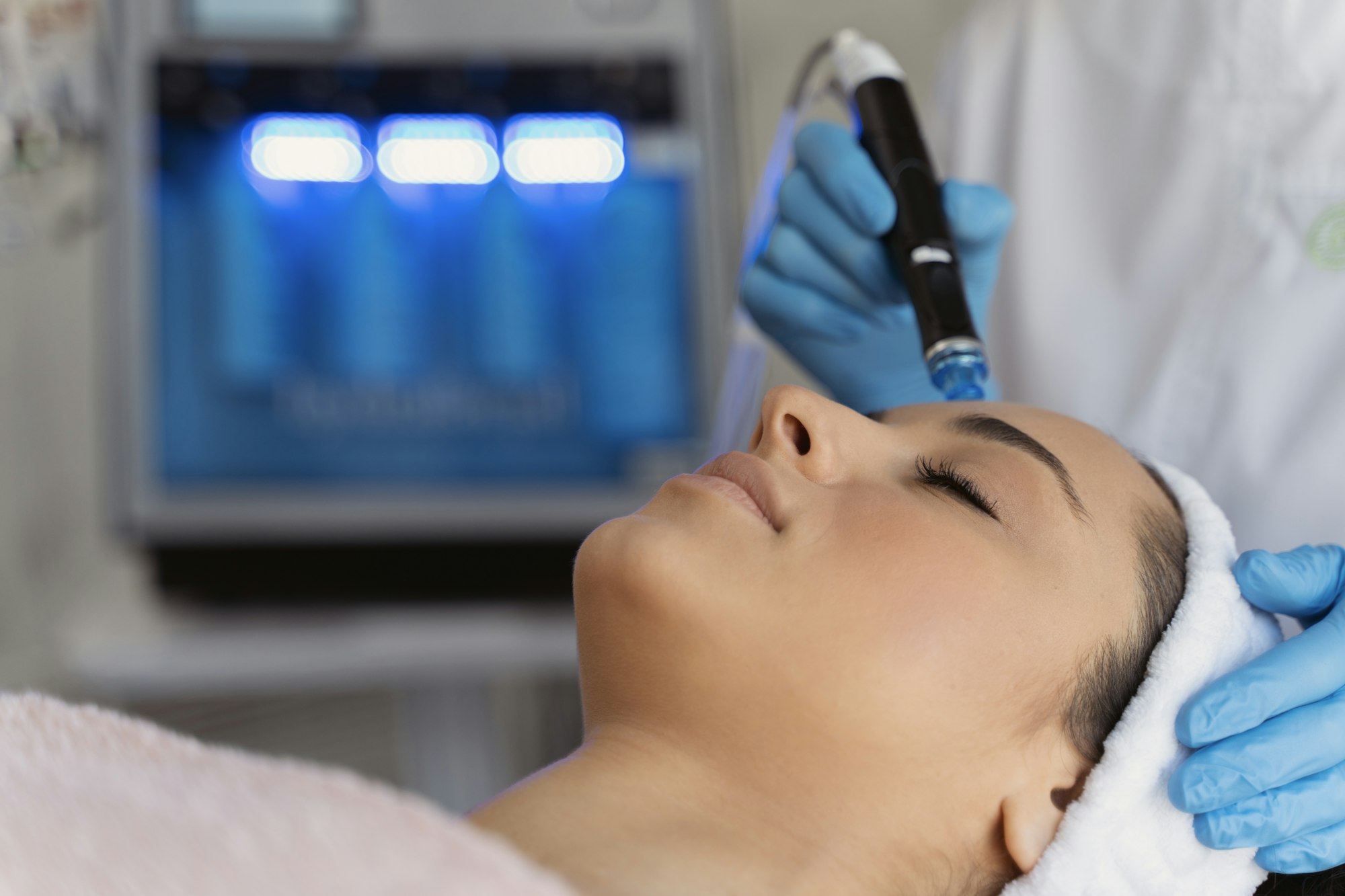 Close-up of woman getting facial hydro microdermabrasion peeling treatment